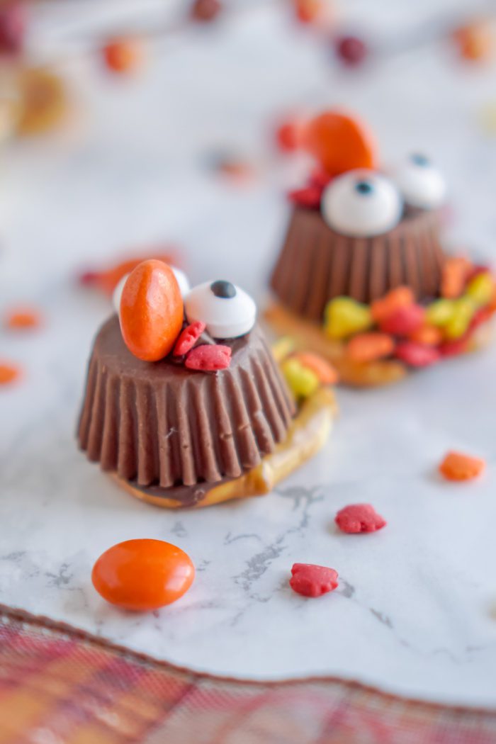 Thanksgiving turkey pretzel treats on marble table.