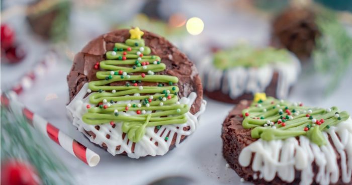 Christmas tree-shaped brownies with white icing.