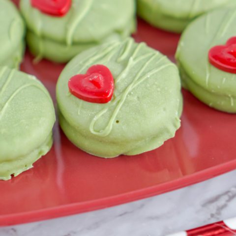 Green cookies with red heart-shaped candies.