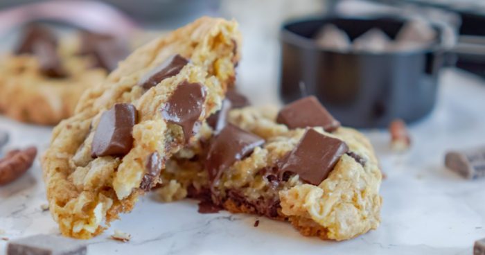 A close-up image of a broken chocolate chip cookie.