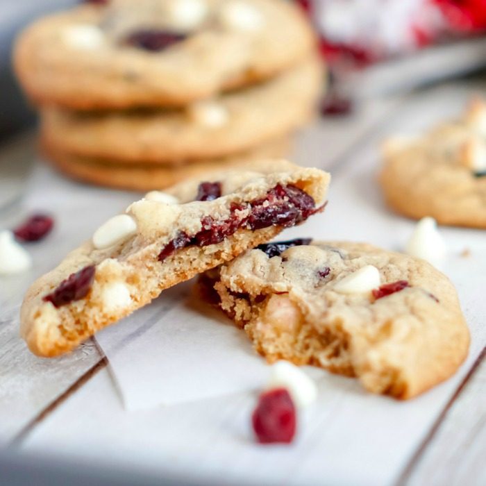 A broken cranberry cookie with white chocolate chips.