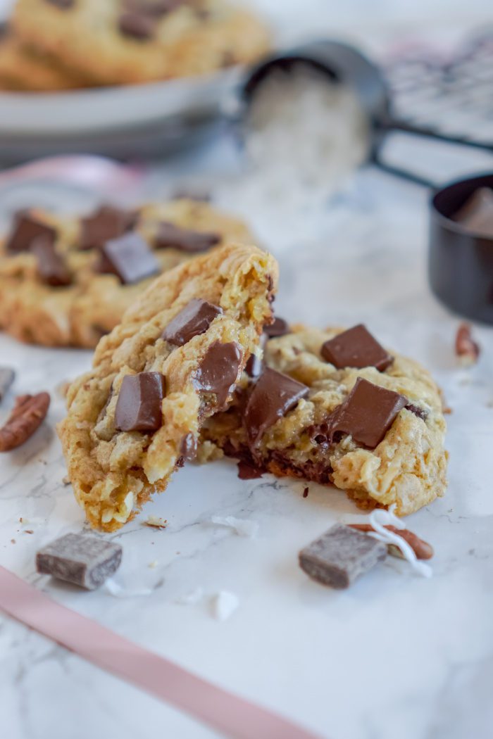 A close-up image of a broken chocolate chip cookie.