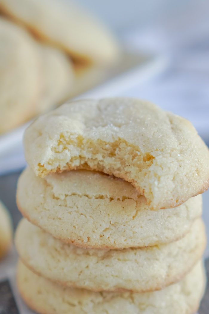 A close-up image of a stack of three sugar cookies.
