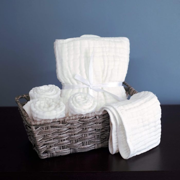 White cloth diapers and socks in a basket.