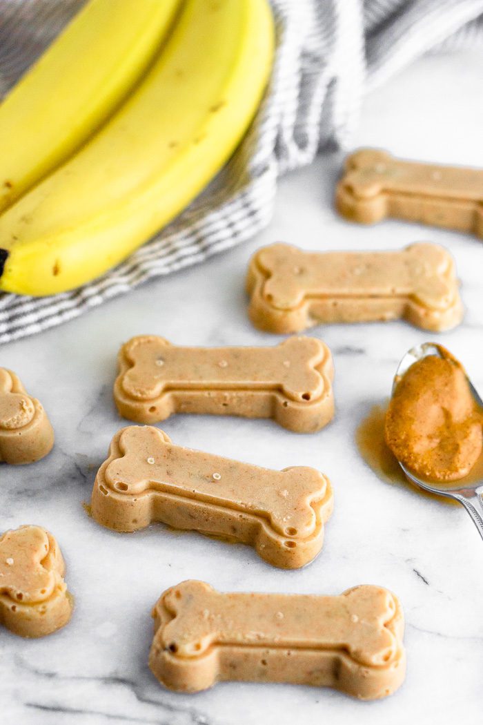 Peanut butter and banana dog treats on marble.