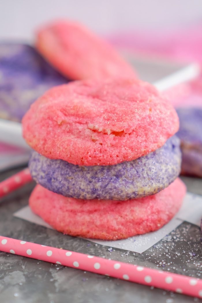 Stack of three pink and purple sugar cookies.