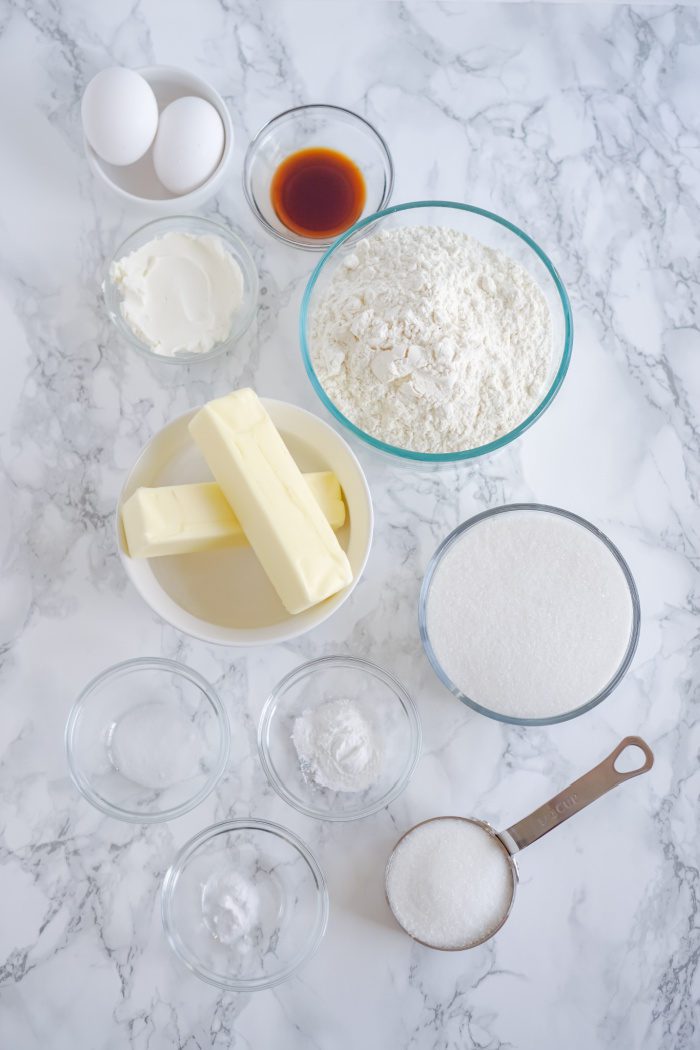 Ingredients for baking a cake on a marble table.