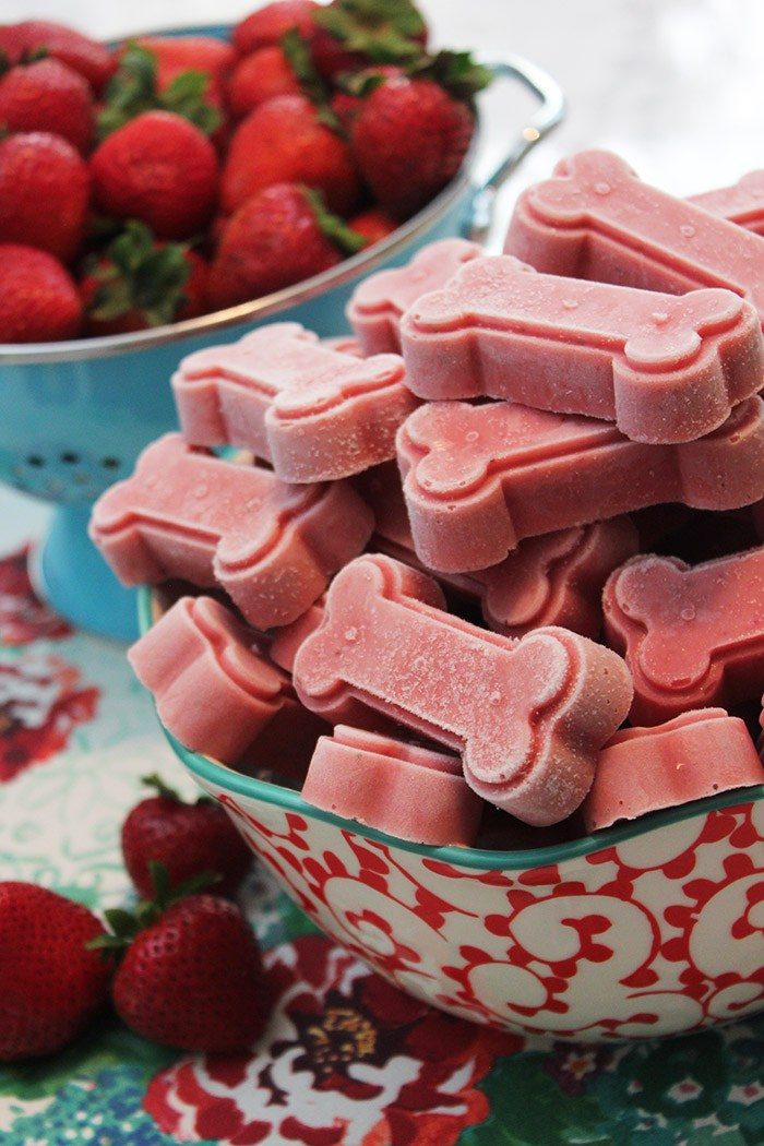 Strawberry-shaped ice cubes in a bowl.