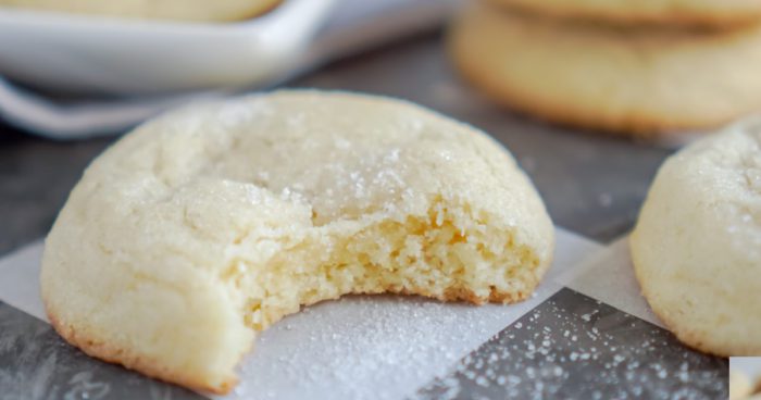 A close-up image of a bitten sugar cookie.