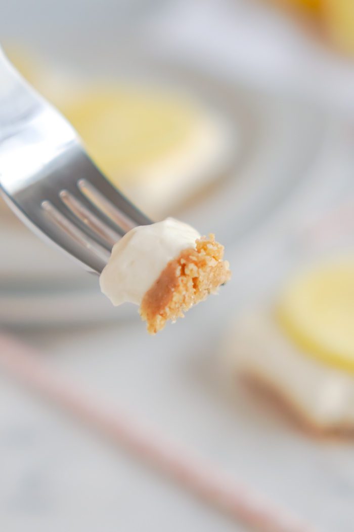 A forkful of lemon cheesecake.