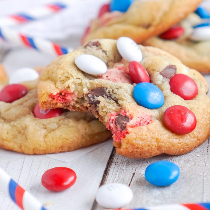 A bitten red, white and blue chocolate chip cookie.