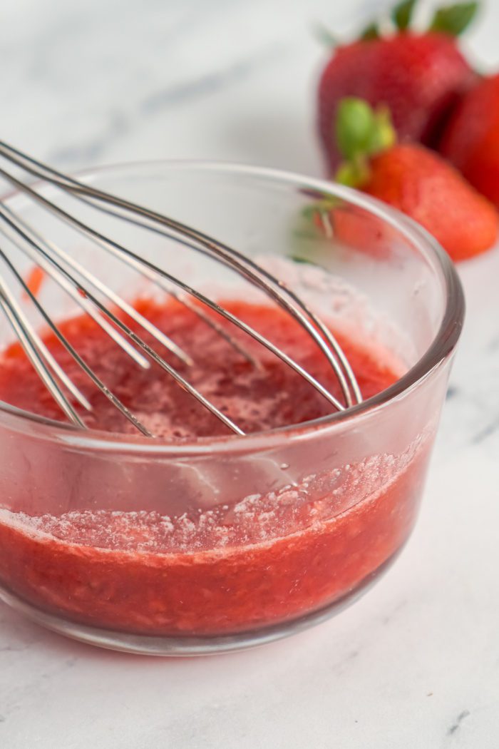 Whisk in a bowl of strawberry puree.