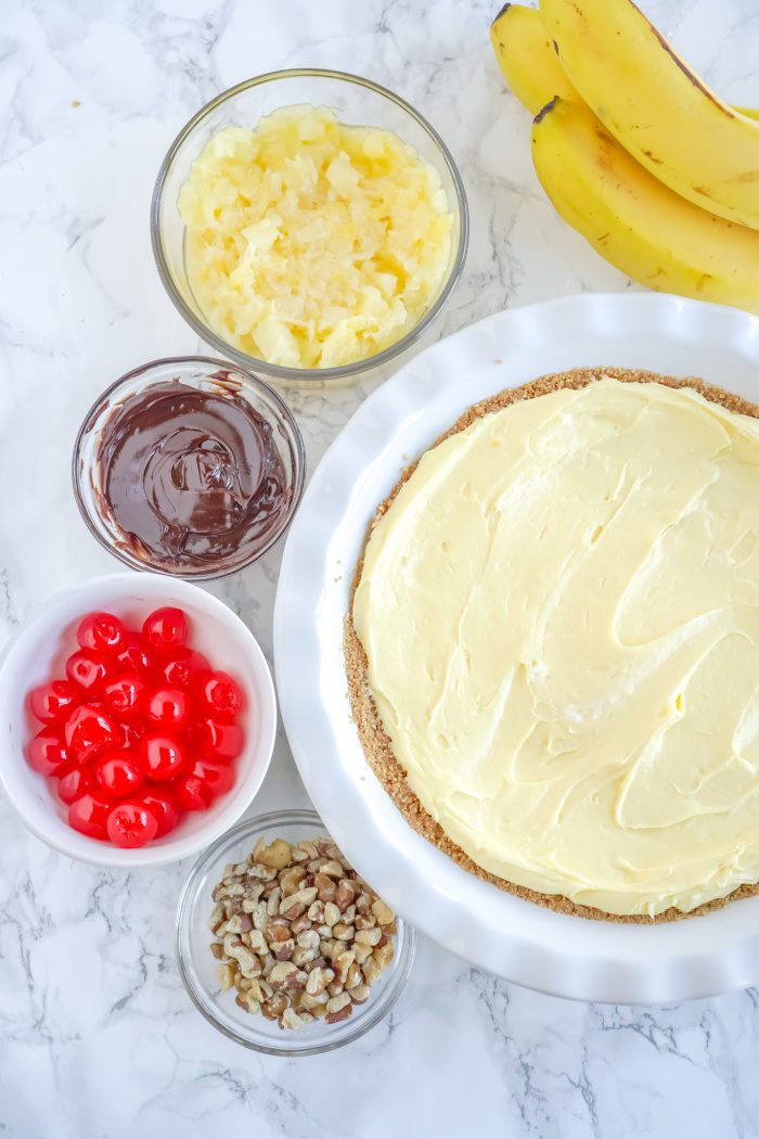 Banana cream pie ingredients on a marble table.