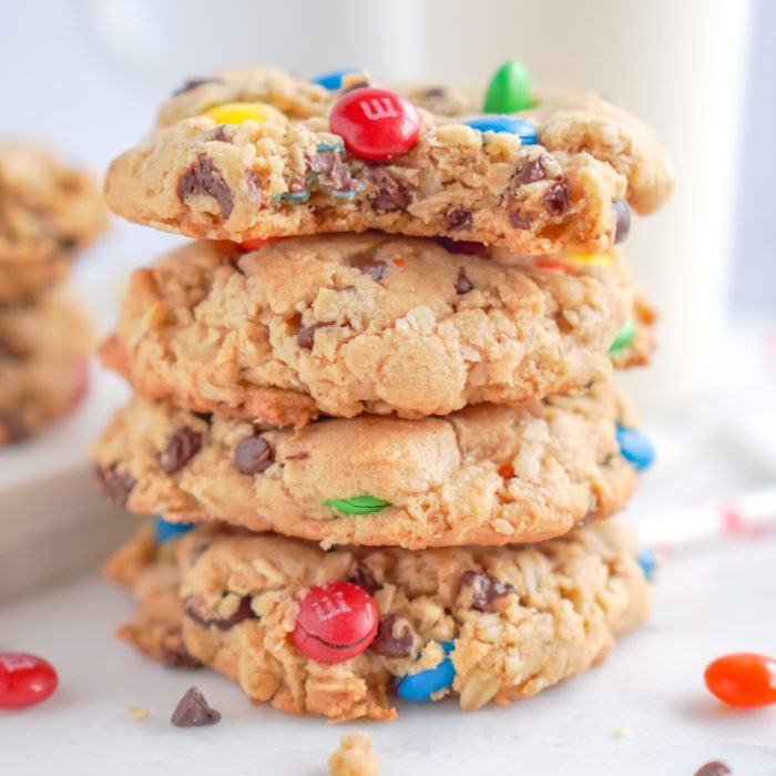 A stack of four oatmeal chocolate chip cookies with M&Ms.