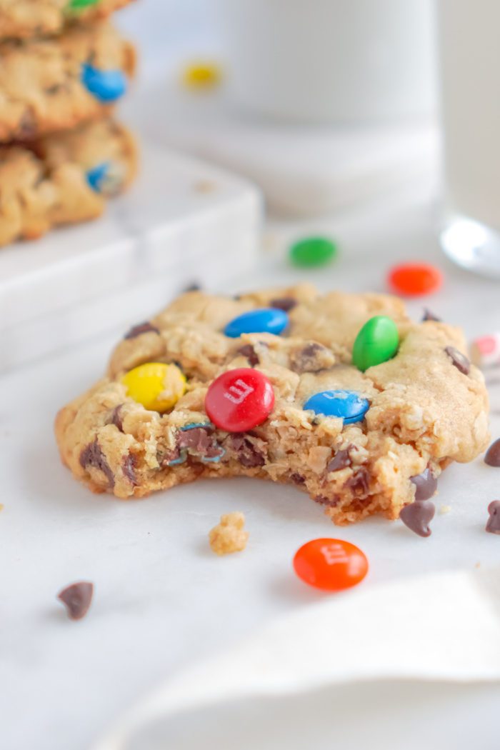 A close-up image of a bitten M&M cookie.