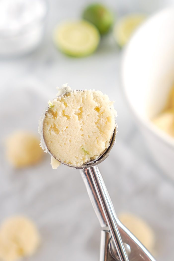 A close-up image of a scoop of lime cookie dough.