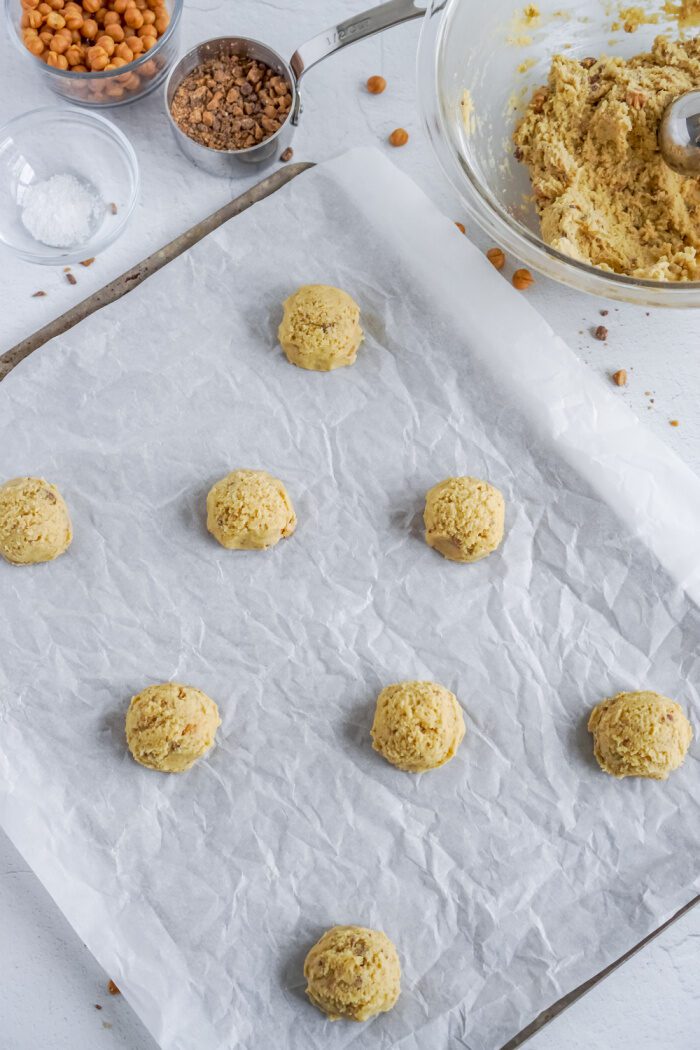 Cookie dough balls on cookie sheet