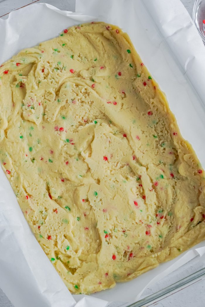 Cookie dough spread out in baking pan