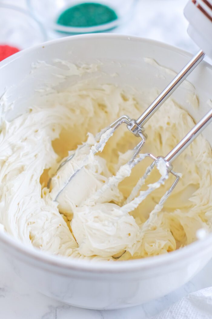 Creamed cream cheese, heavy whipping cream, and vanilla in a bowl