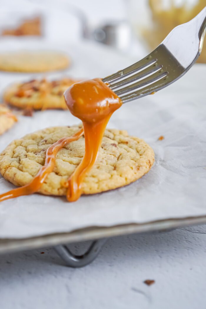 Drizzling caramel over cookie