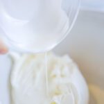 Heavy whipping cream being poured into bowl