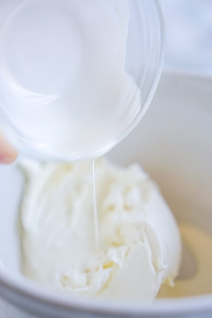 Heavy whipping cream being poured into bowl