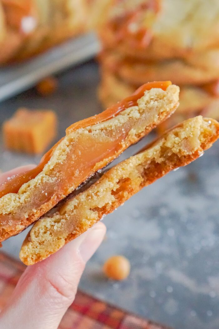 A close-up image of a broken cookie with a soft caramel center.