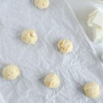 Cookie dough balls on baking sheet
