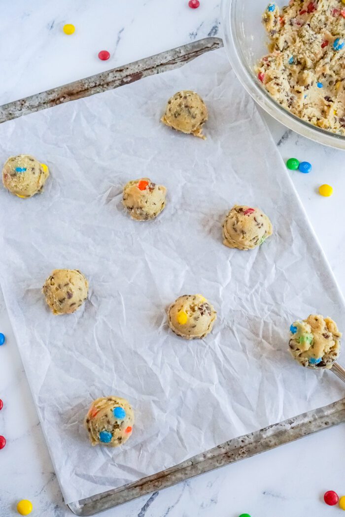 Cookie dough balls on baking sheet