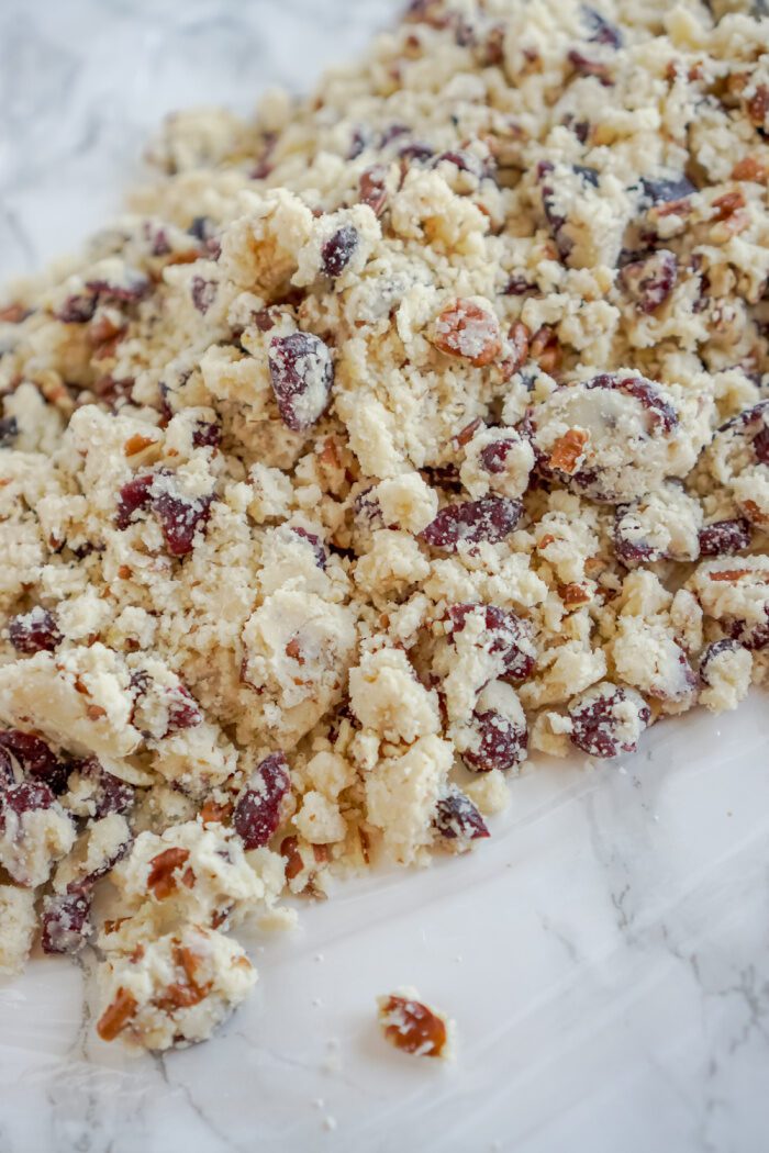 Cookie dough spread out on plastic wrap