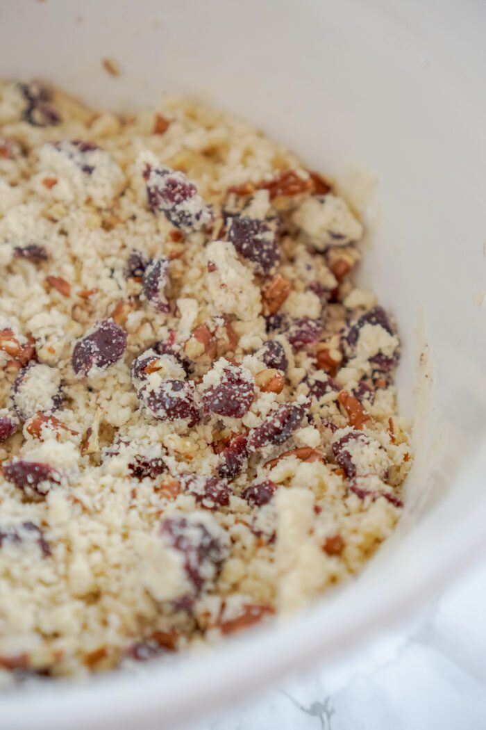 Crumbly cookie dough with cranberries and pecans