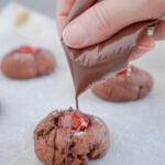 Drizzling almond bark over baked cookies