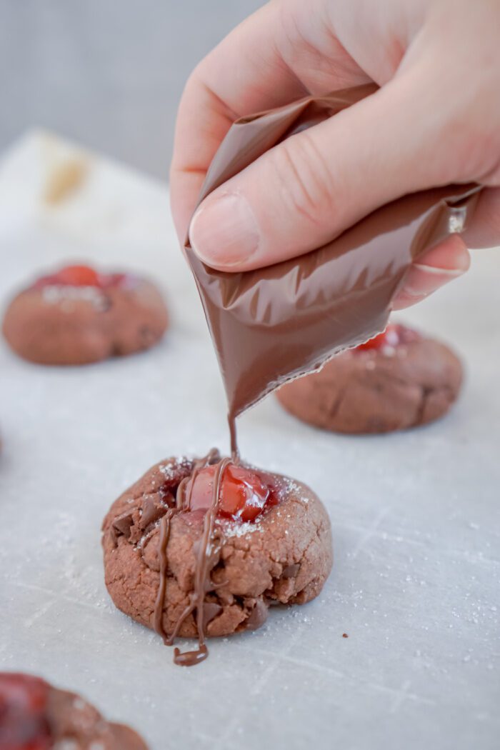 Drizzling almond bark over baked cookies