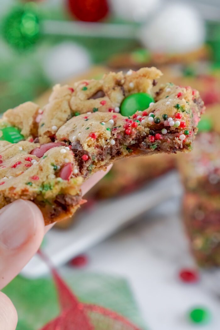 Someone Holding a Chocolate Chip M&M Cookie Bar