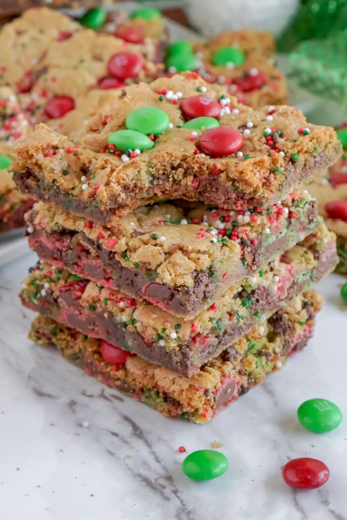 A stack of four Christmas-themed cookie bars.