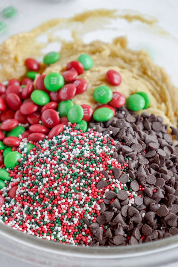 Mini chocolate chips, M&Ms, and holiday sprinkles added to cookie dough