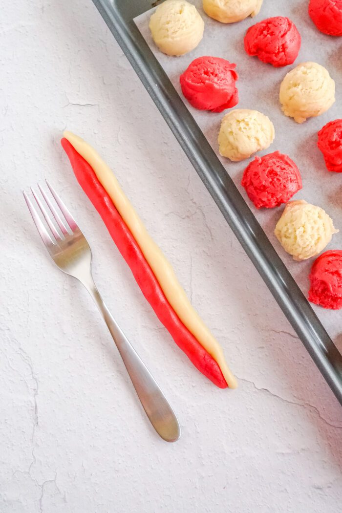 Red and white cookie dough logs pressed together