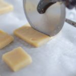 Slicing cut out cookies into mini square cookies