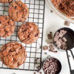 Topping baked cookies with more chocolate pieces