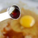 Vanilla and egg being added to bowl