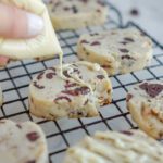 White chocolate being drizzled on cookie