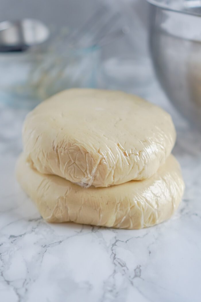 Cookie Dough Divided In Two and Wrapped in Plastic Wrap