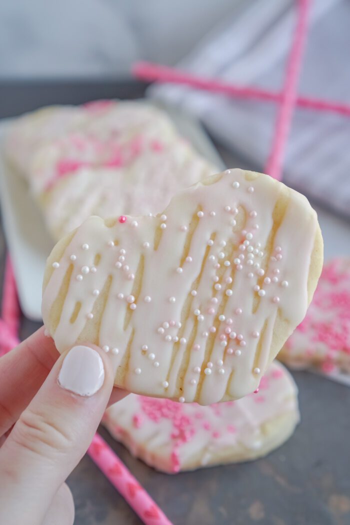 Someone Holding A Frosted Valentine's Day Cookie