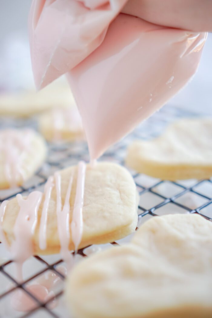 Icing Being Drizzled on Sugar Cookies