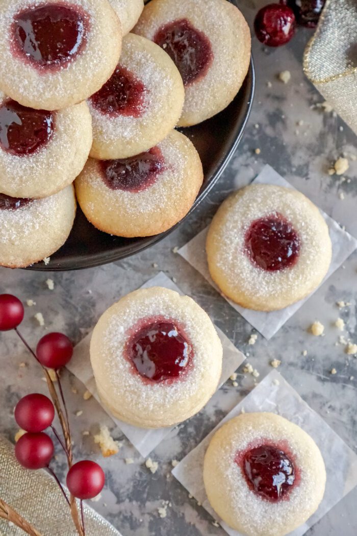 Lots of Raspberry Thumbprint Cookies On and Off a Plate