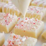 White Almond Bark Being Drizzled Over Fudge Squares