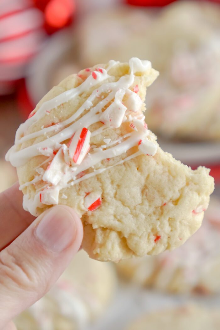 Someone holding a Peppermint Cookie with a bite taken out of it