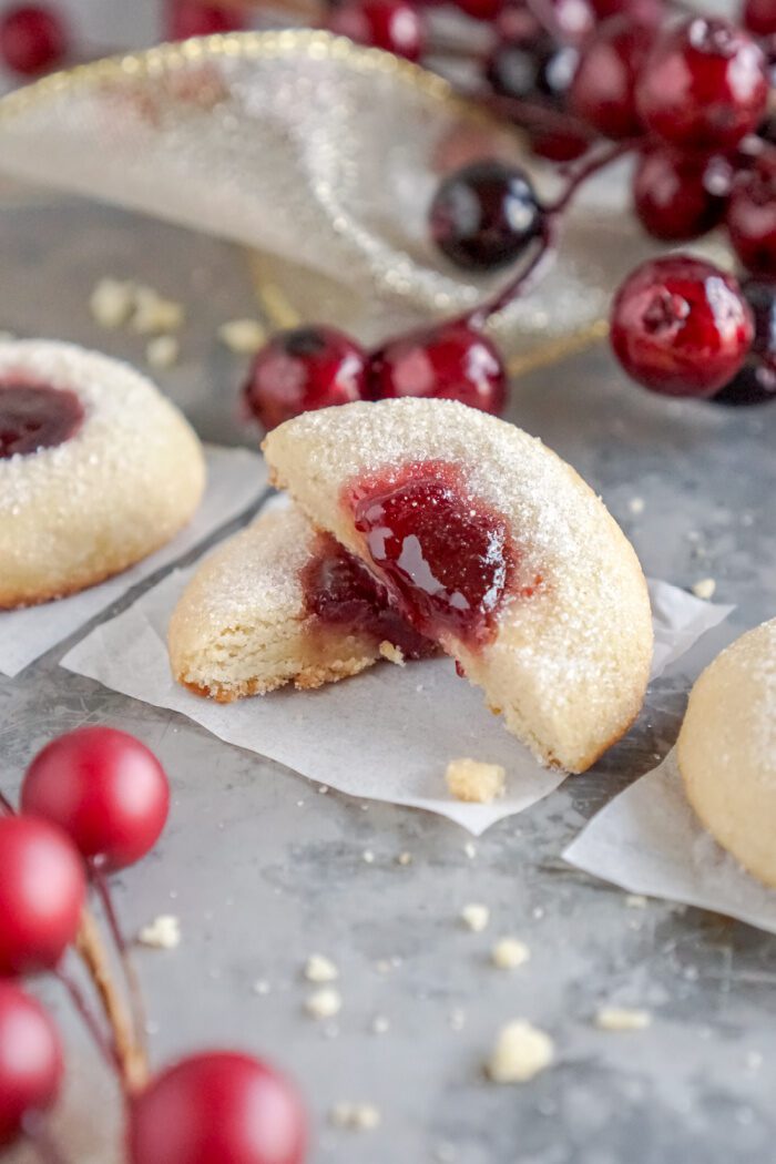 Raspberry Thumbprint Cookie cut in half and propped up on itself