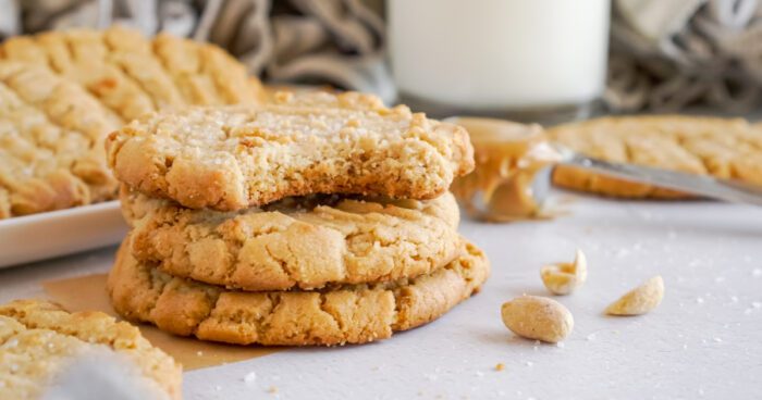 Wide view of a stack of Peanut Butter Cookies with a bite taken out of the top cookie