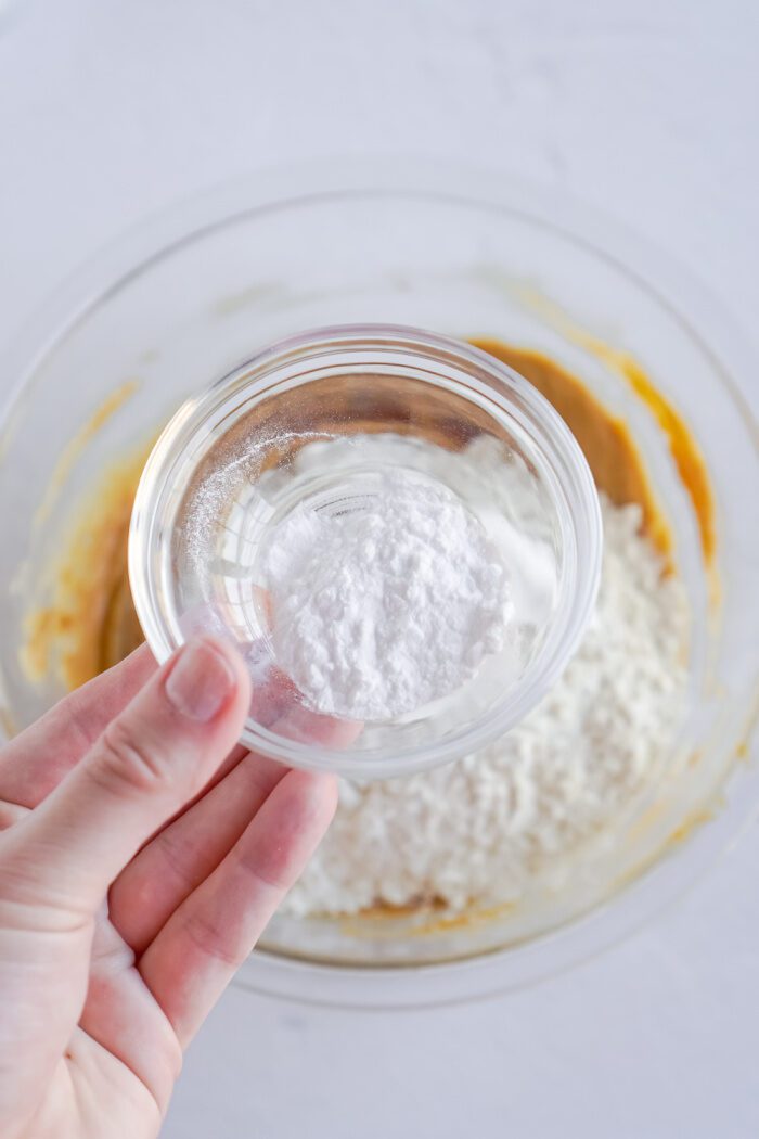 Baking soda being added to bowl